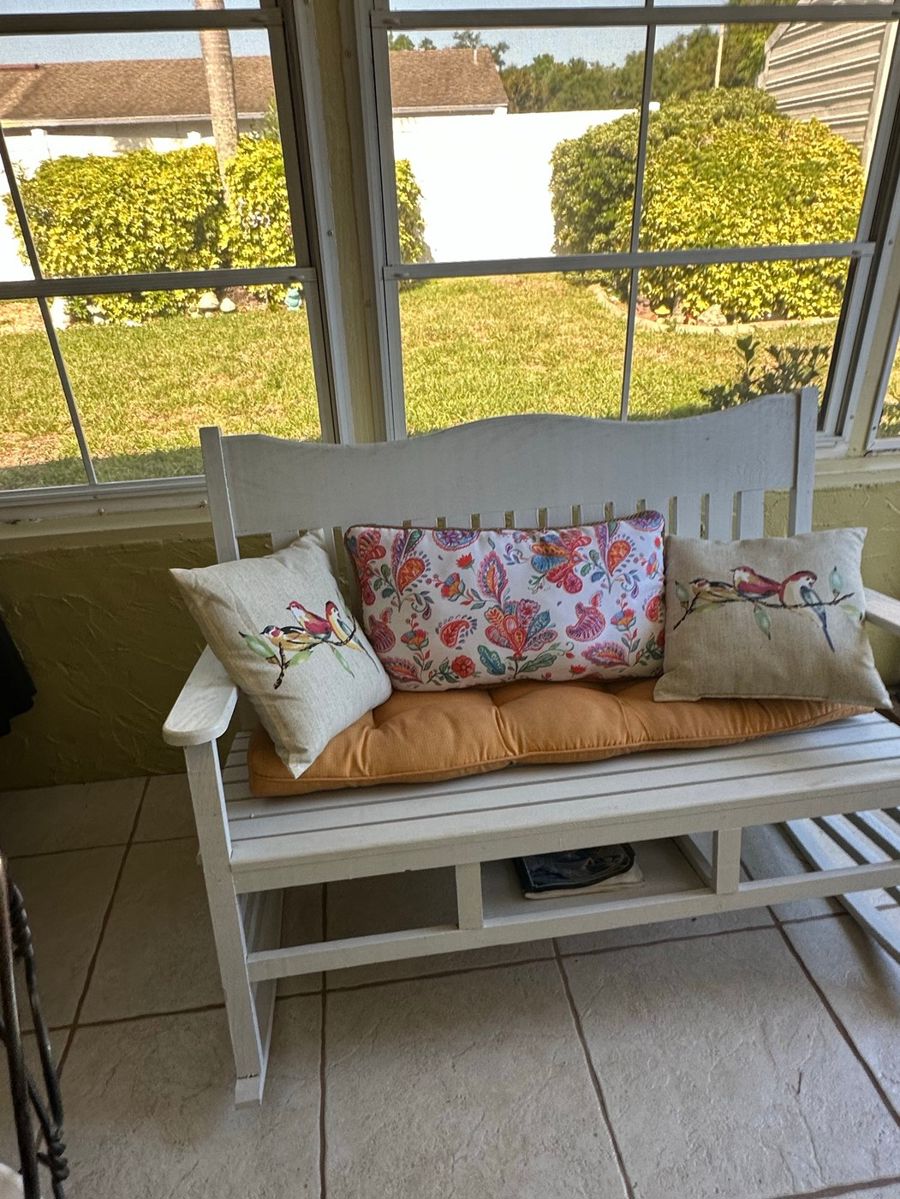 White Wooden Slat Bench with Outdoor Cushion & Decorative Pillow Grouping
