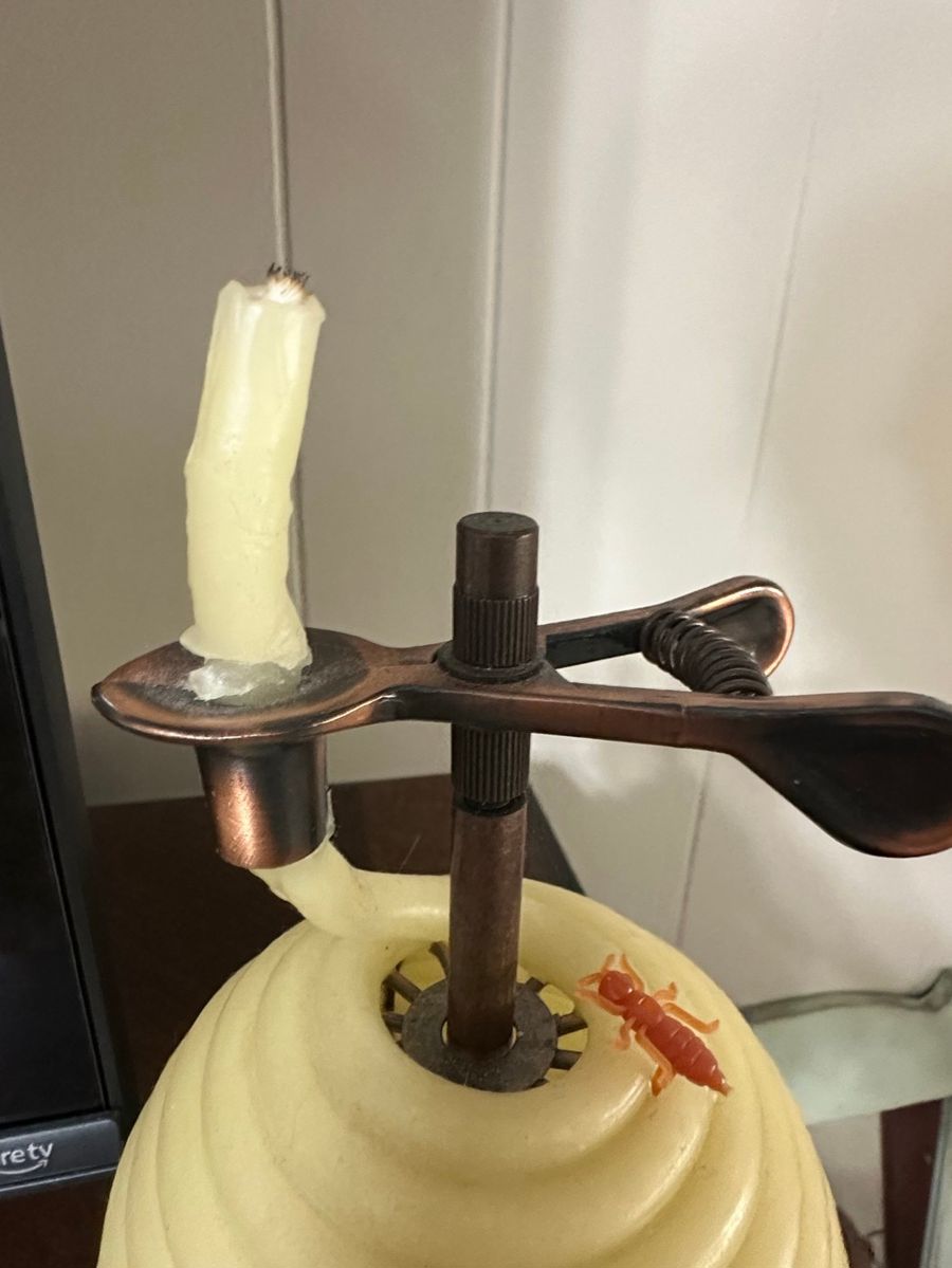 Whimsical Decorative Candle Holder with Spinning Spoon Arms and Novelty Insect