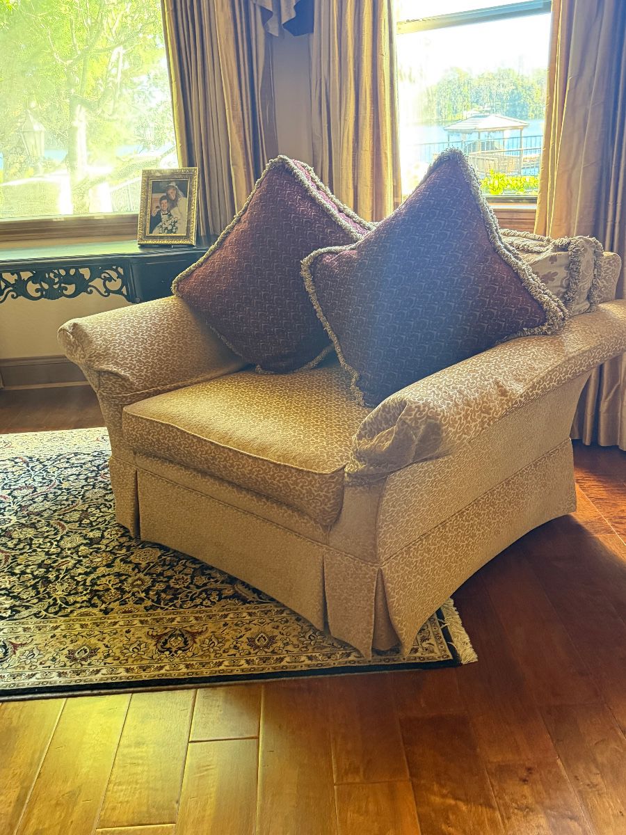 Upholstered Armchair with Throw Pillows and Area Rug
