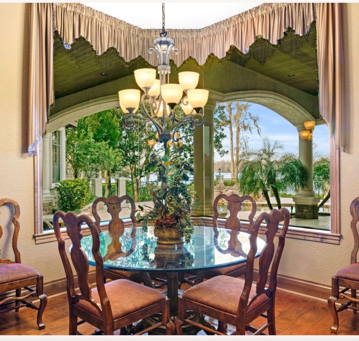 Dining Room Set with Ornate Chandelier and Pedestal Table