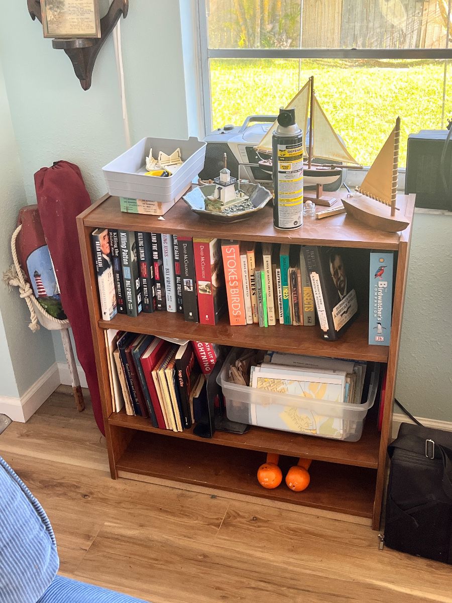 Bookshelf Assortment with Maritime Decor and Literature